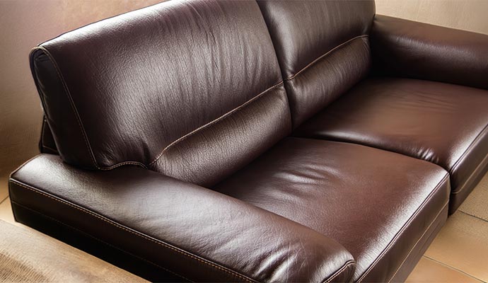 A close-up view of a premium dark brown leather sofa