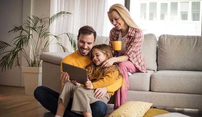 A happy family sitting together in a living room
