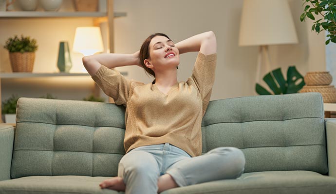 A relaxed woman sitting on a sofa