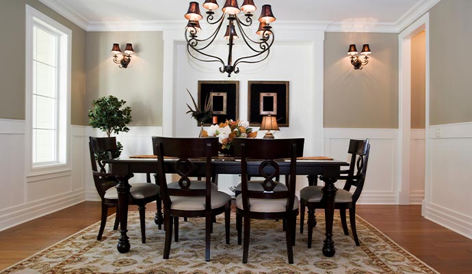 An elegant dining room featuring a dark wood table and chair set