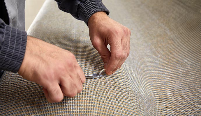 A person repairing carpet