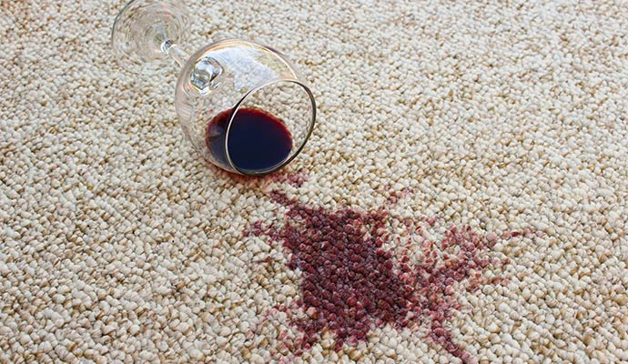 Red wine stain on white carpet