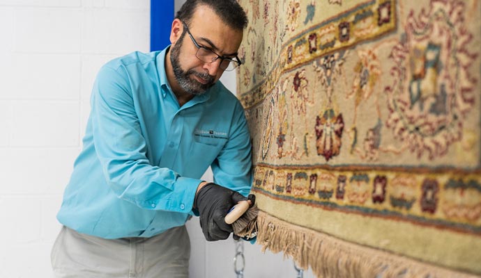 A person cleaning rug