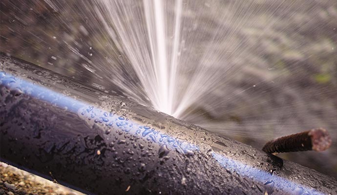 Water leaking from a damaged pipe