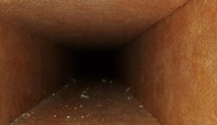 Dirty air duct interior with dust buildup