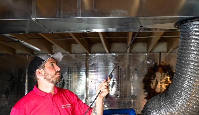A professional sanitizing air duct using specialized equipment