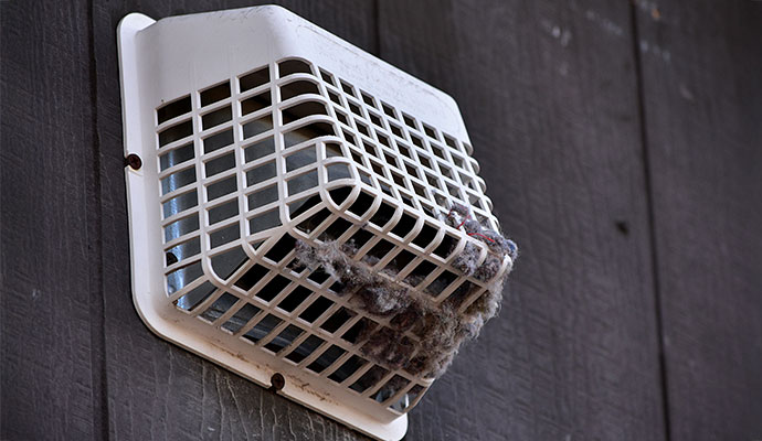 Clogged exterior dryer vent bird guard lint buildup