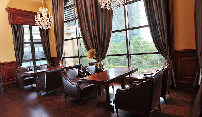 Formal lounge with leather chairs and drapery