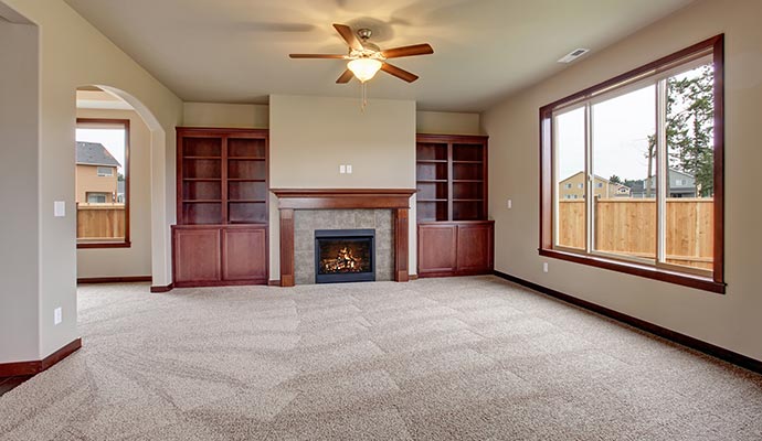 Living room with beige carpet and fireplace