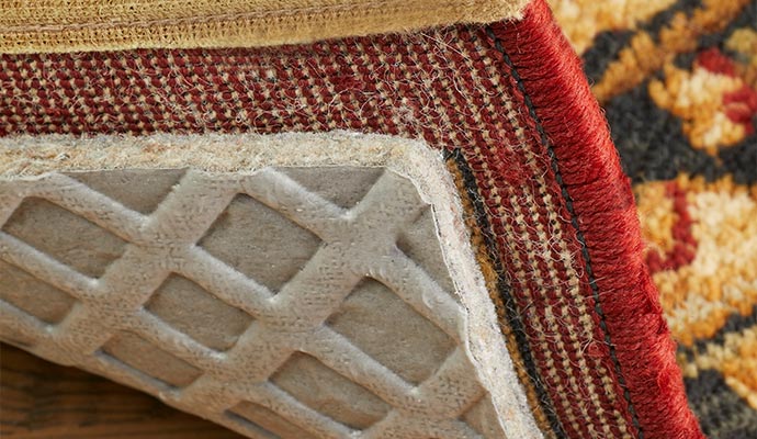 Protective rug pad underneath corner of oriental area rug