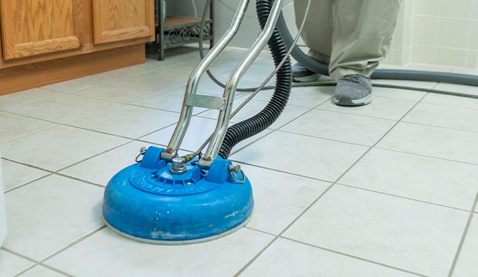 Rotary machine cleaning and scrubbing tile and grout floor