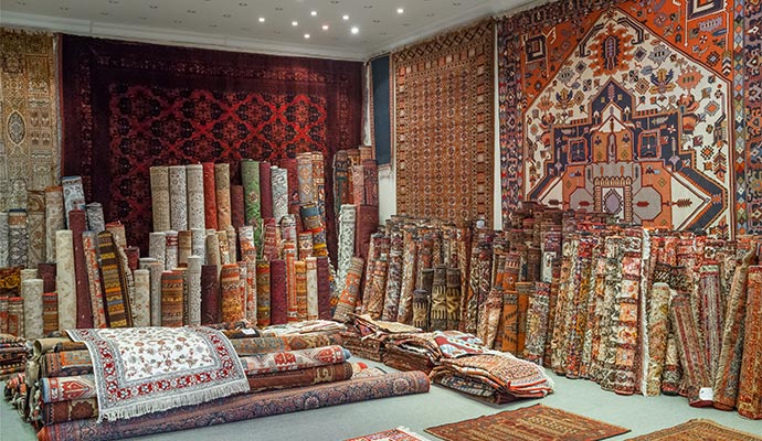 Showroom with rolled and hanging area rugs