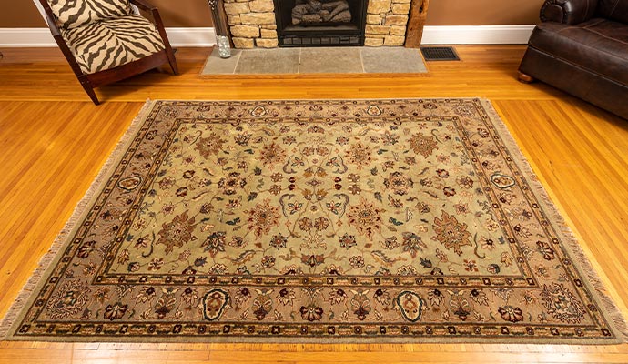 A clean oriental area rug on a polished hardwood floor in a living room