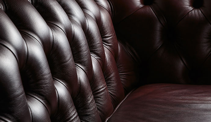 Close-up of tufted brown leather sofa
