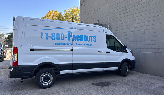 White Packouts van parked outside commercial building