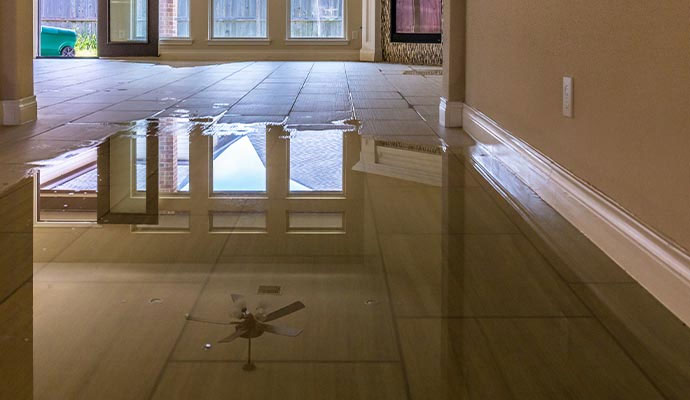 Indoor tile floor covered with standing water from flooding
