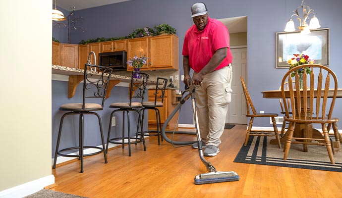 Technician cleaning hardwood floor