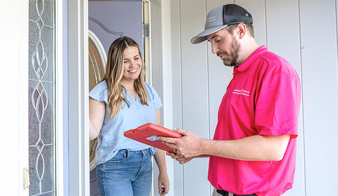 Technician reviewing tablet with homeowner
