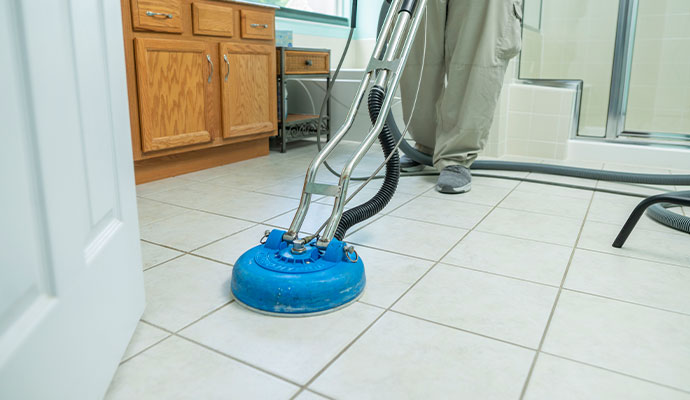 An expert cleaning tile floor using a professional cleaning machine