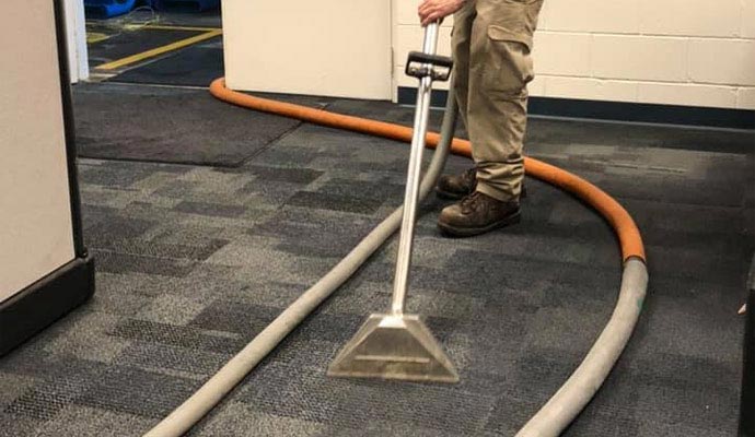 Water extraction service from carpet in a commercial space